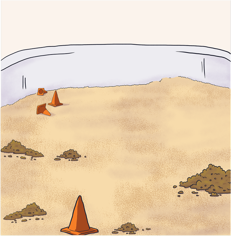 Background for “El volcán” and “Crane Rescue”: a sand sensory table with cones and small piles of dirt.