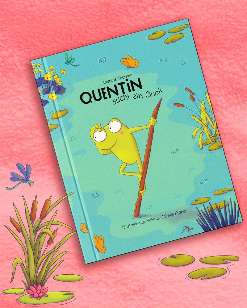 Maqueta del libro «Quentin sucht ein Quak» sobre una tela rosa: la tapa turquesa muestra una rana verde de ojos grandes apoyada en una caña, entre juncos y nenúfares.